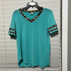 Blue top with leopard details. Small but fits like a medium loose